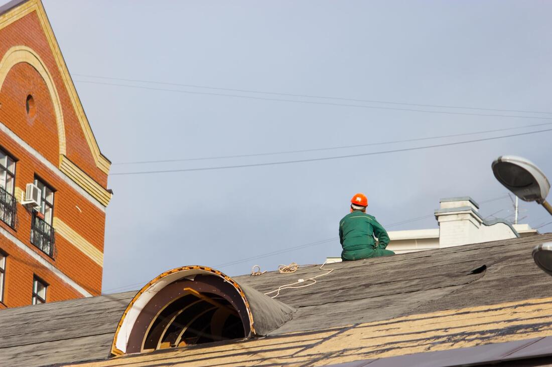 man at the top of the roof